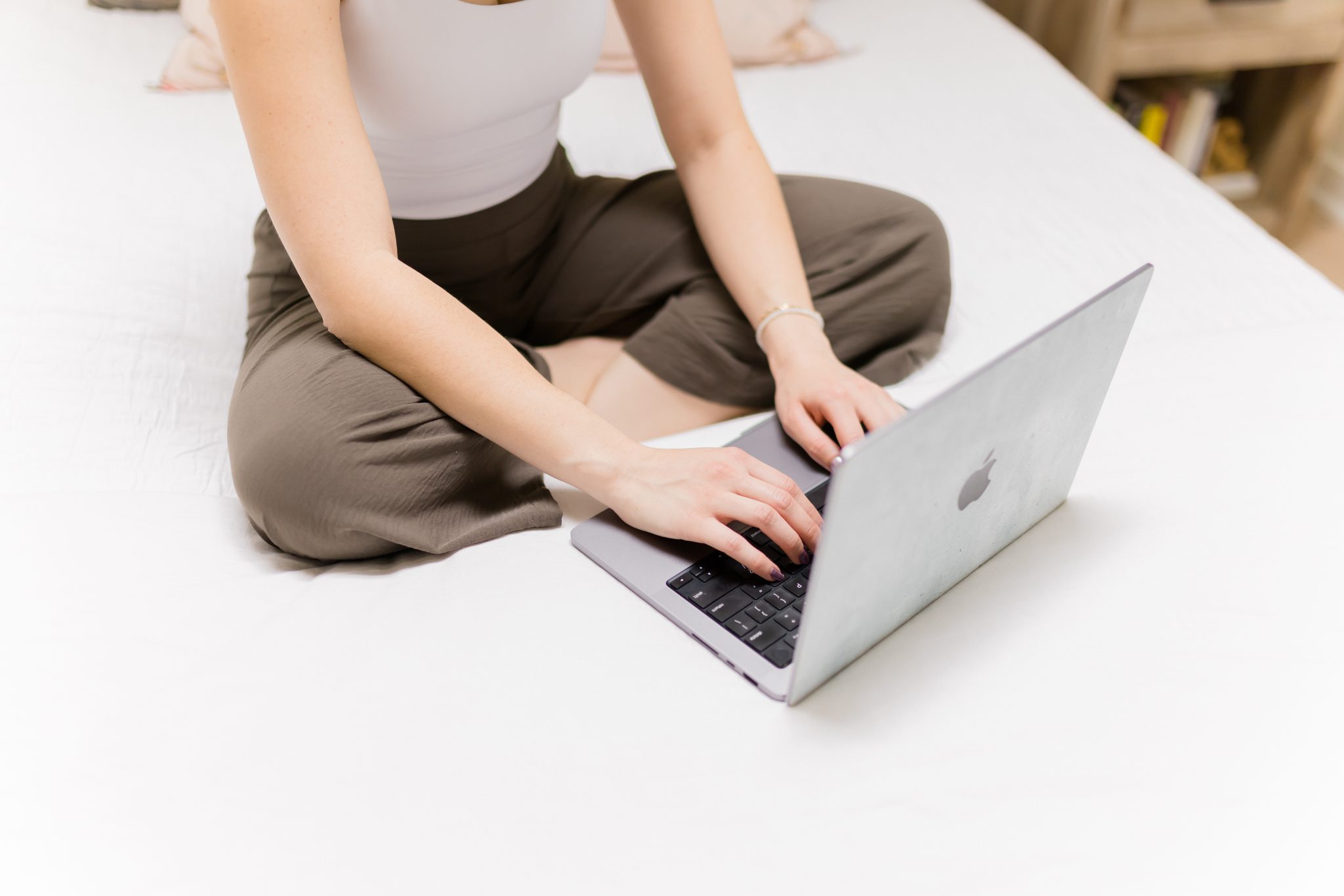 A photo of a yogi typing on a computer for the Contact Us page of the website.